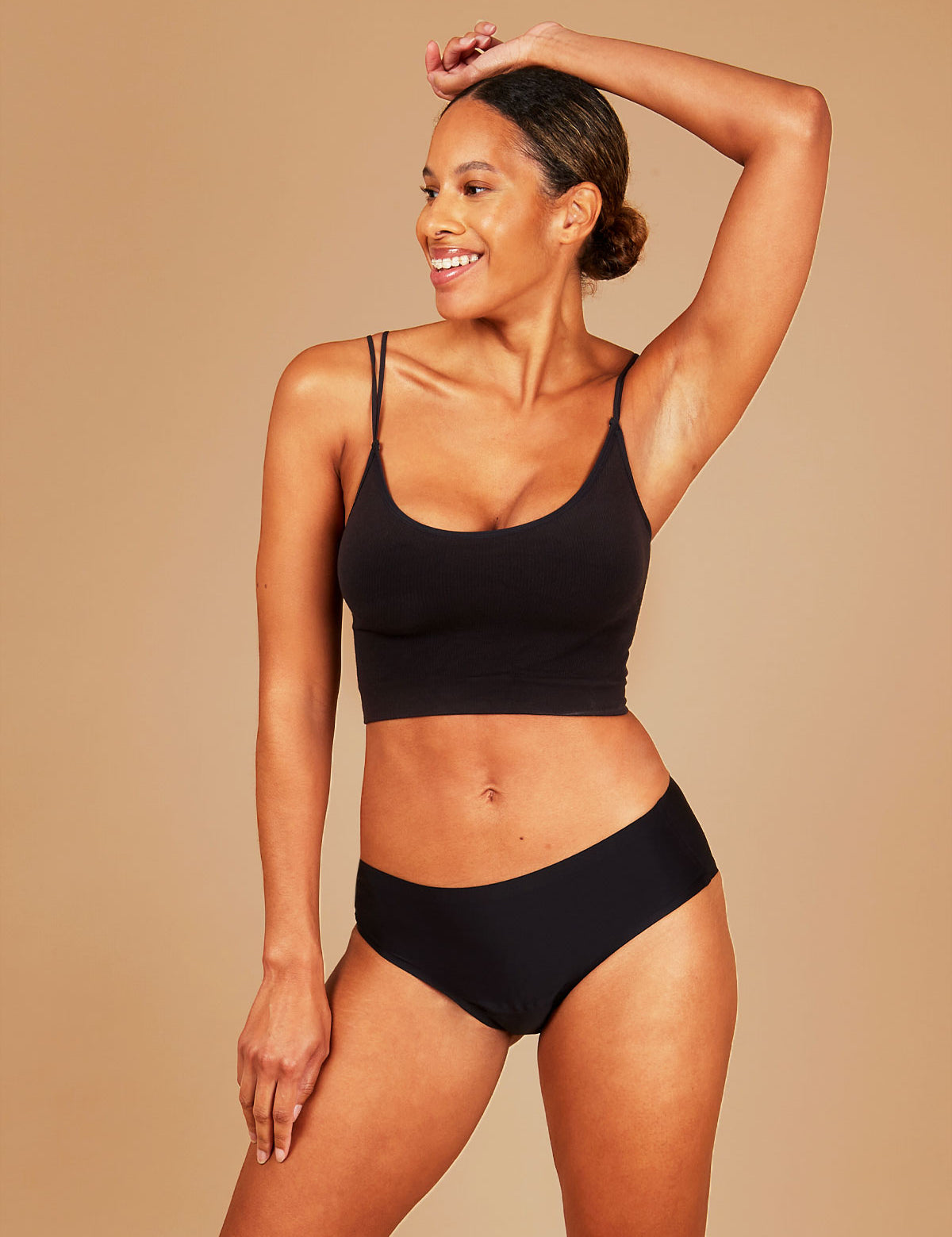 Leakproof seamless period underwear, woman expressing joy.